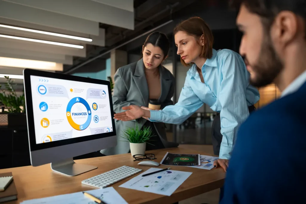 Team analysing HR performance graphs on a computer